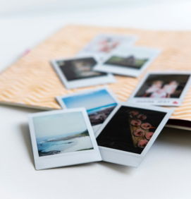 photos-on-white-wooden-table.jpg photos on white wooden table